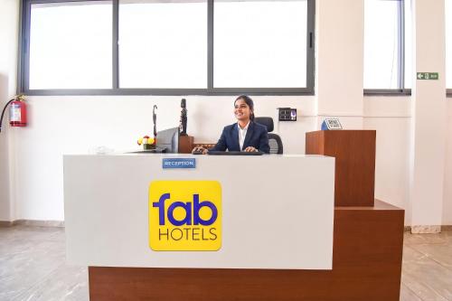 a woman sitting at a desk in an office at FabHotel DSP in Pune