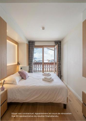 a bedroom with a large bed with a window at Funiculaire collection in Tignes