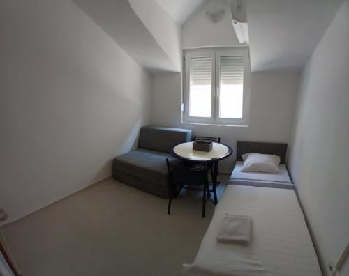 a small room with a couch and a table at Apartman Vuk in Budva