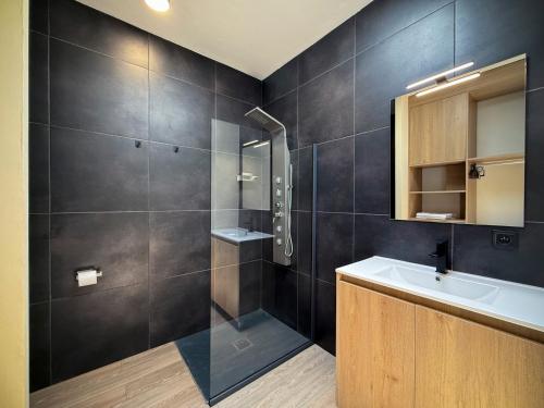 a bathroom with a sink and a shower at Villas 21 in Nosy Be