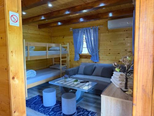 a living room with a couch and bunk beds at Etno kutak Milojevic in Paraćin