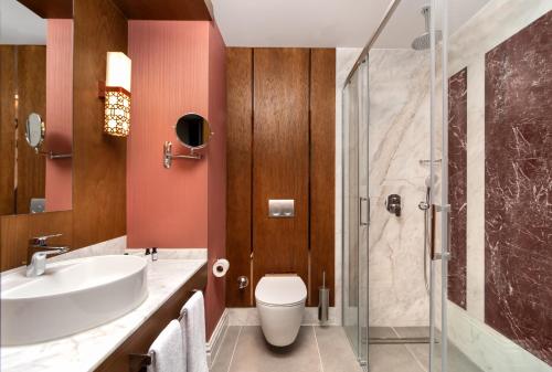 a bathroom with a sink and a toilet and a shower at Aspera Hotel Taksim in Istanbul