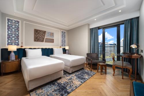 a hotel room with a bed and a desk at Aspera Hotel Taksim in Istanbul