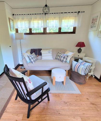 a living room with a couch and a chair at Ferienhaus Stensjö in Holmsjö