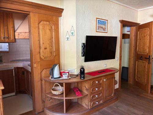 a kitchen with a television on a wooden table at Residence Intica in San Candido
