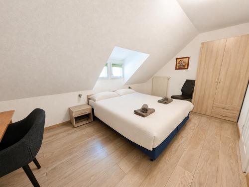 a bedroom with a bed and a desk and a chair at Wald Villa Üssbach in Alf
