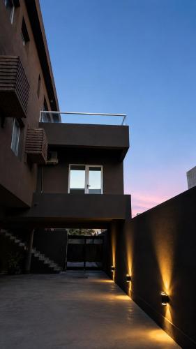 a building with a walkway in front of a building at La ola in Puerto Pirámides
