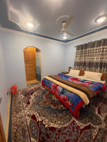 a bedroom with a bed in a room with a rug at Urban Den Hostel in Srinagar