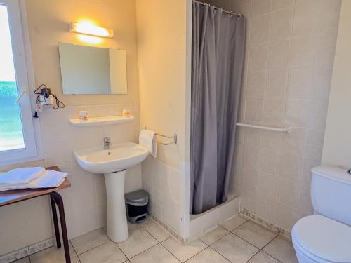 a bathroom with a sink and a shower curtain at Résidence Torre Del Far in Tautavel