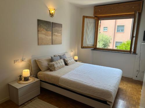 a bedroom with a large bed and a window at La casa di AngeLis in Stezzano
