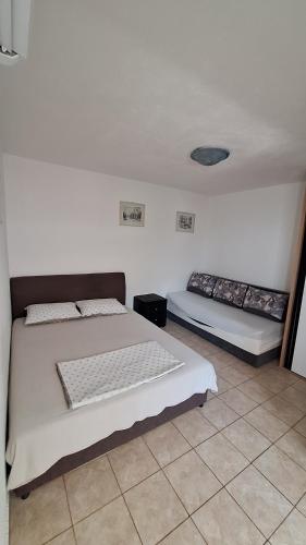 a bedroom with two beds in a room at rašo in Pržno