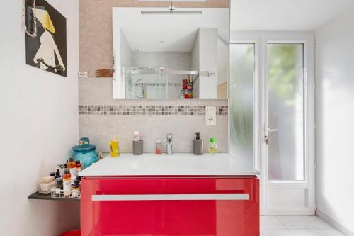 a red and white kitchen with a red cabinet at Lacelledort in La Celle-Saint-Avant
