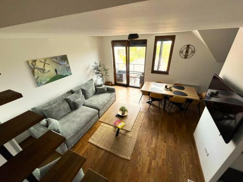 a living room with a couch and a table at Apart kompleks Binis in Zlatibor