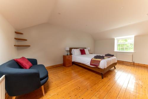 a bedroom with a bed and a chair at Stone House , Boyne Valley Views in Donore