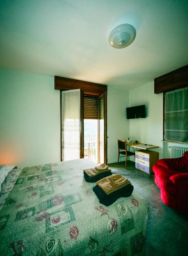 a bedroom with a large bed and a desk with at Casa Lilli in Zogno