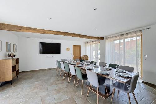 a large dining room with a long table and chairs at Maisons de Familles Quiet family-friendly vacation rental with a spa in Équilly