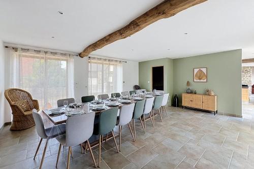 a large dining room with a long table and chairs at Maisons de Familles Quiet family-friendly vacation rental with a spa in Équilly