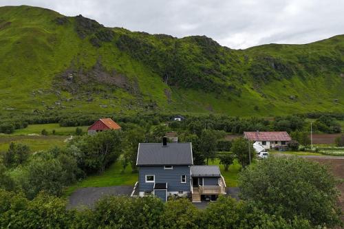 an aerial view of a house and a mountain at Panorama Valley Lofoten in Bøstad