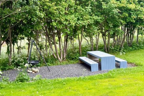 a blue bench sitting in the middle of a park at Panorama Valley Lofoten in Bøstad