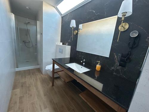 a bathroom with a sink and a mirror at Villa Verden in Łomża