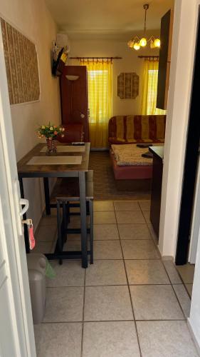 a kitchen and living room with a table and a couch at Adria penzión in Štúrovo
