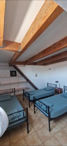 three beds in a room with a attic at Appartement plein centre-ville in Lodève