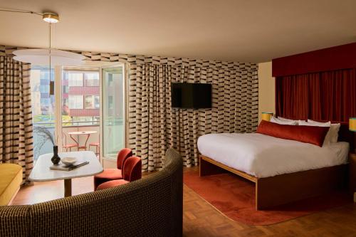 a bedroom with a bed and a living room at Locke am Platz Zurich in Zurich