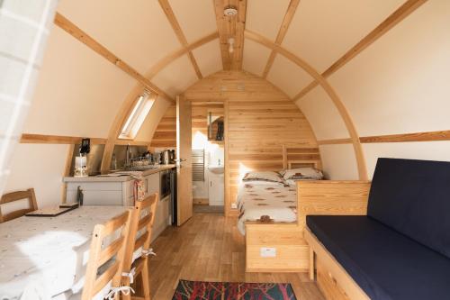 a room with two beds and a kitchen in a house at Rivendell Farm Glamping in Carmarthen