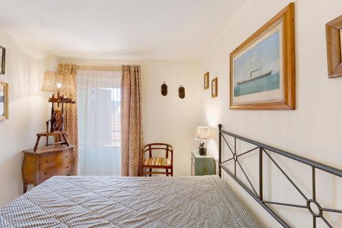 a bedroom with a bed and a chair and a window at Pietra Viva in Poggio