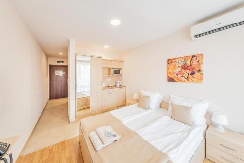 a bedroom with a large bed in a room at Premier Fort Beach Hotel in Sveti Vlas