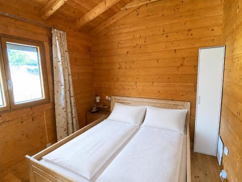 a bedroom with a bed in a wooden room at Blockhaus Nikolaus in Güssing
