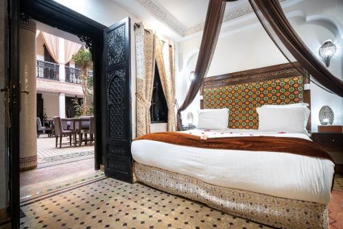 a bedroom with a bed with an ornate headboard at Hotel & Ryad Art Place Marrakech in Marrakesh