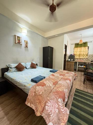 a bedroom with a large bed in a room at spectrum hub beach side apartment in Candolim