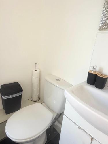 a white bathroom with a toilet and a sink at Relaxing Private Bedroom Stay in Hull
