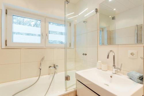 a bathroom with a tub and a sink and a shower at Haus MARGOT by MoniCare in Seefeld in Tirol