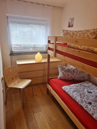 a bedroom with a bunk bed and a desk at Appartement SISI by MoniCare in Seefeld in Tirol