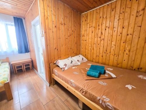 a bedroom with a bed in a wooden wall at Summer Vibe Costinesti in Costinesti