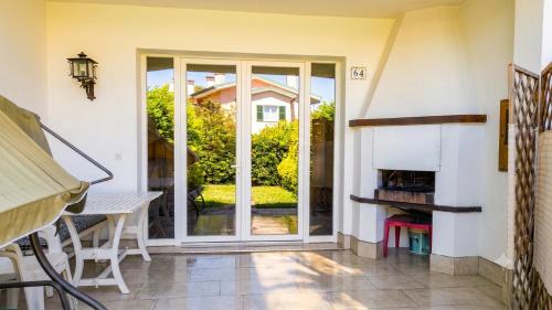 a living room with a sliding glass door at Villa Duna Verde in Duna Verde