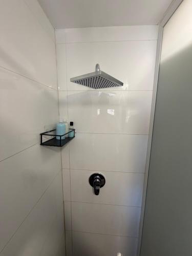 a bathroom with a white wall and a light at Room 805 in Eilat