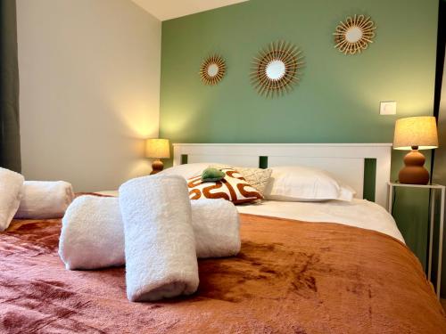 a bedroom with a large bed with two mirrors on the wall at Entre Terre et Vignes - Studio climatisé in Marlenheim