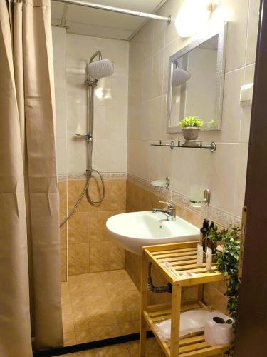 a bathroom with a sink and a shower at Family Hotel Brilliance in Varna City