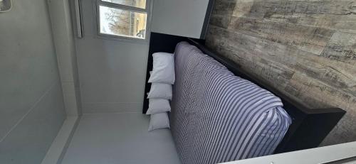a couch with pillows sitting next to a window at A magical get away experience in Matlock