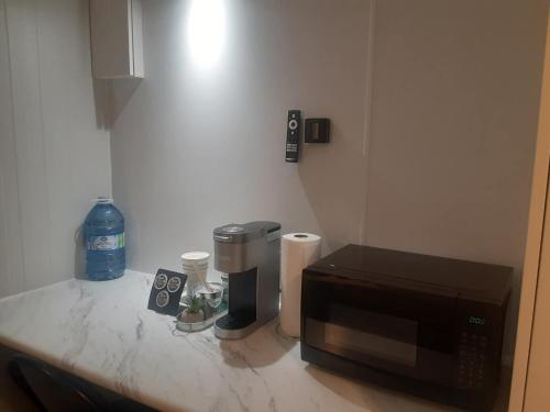 a kitchen counter with a microwave and other appliances on it at A magical get away experience in Matlock