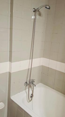a shower in a bathroom with a white tub at Cantinho de Matosinhos in Senhora da Hora