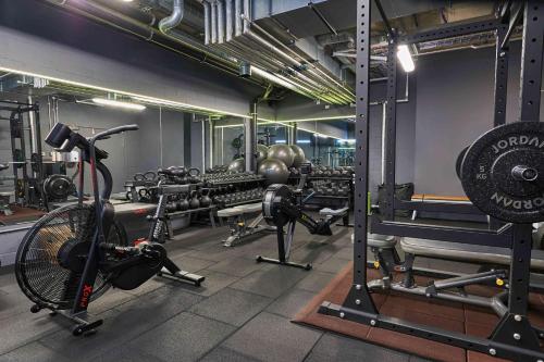 a gym with a bike and weights in a room at Buckle Street Studios by Locke, Aldgate in London