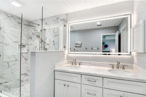 a white bathroom with two sinks and a mirror at 106 Shore Rush Trail in Blackbanks