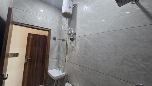 a bathroom with a toilet and a sink and a light at Hotel dream house 2 in Murādnagar