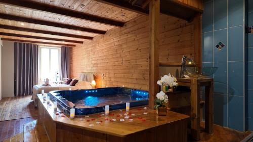 a room with a tub in the middle of a room at Hotel La Font Vineuse & Spa in Saint-Pierre-dʼArgençon