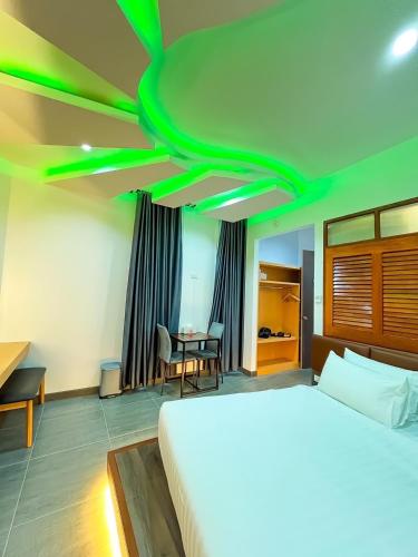 a bedroom with a bed and a desk and a table at เซฟเฮ้าส์ รีสอร์ท in Pattani
