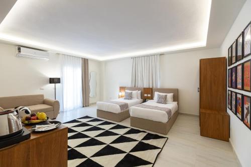 a hotel room with a bed and a couch at Seven Stays Centric West Zayed in Sheikh Zayed